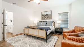 Retreat to the master suite on the main level, where luxury awaits with a sumptuous king-size bed dressed in premium linens.