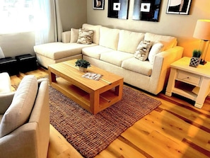 Unwind in Style: Sink into plush seating in the spacious living room, where modern design meets cozy comfort, creating the perfect ambiance for relaxation after a productive day