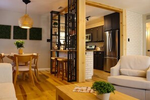 Savor Every Moment: Gather around the stylish dining area adjacent to the kitchen, perfect for enjoying home-cooked meals and creating lasting memories with loved ones