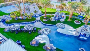 This vibrant daytime photo captures the heart of Lazy River Resort's private water park.