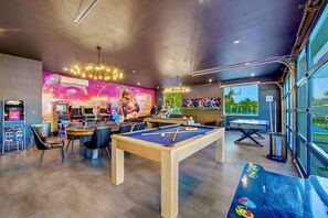 This expansive game room is decked out with pool, ping pong, air hockey, and a theater-style lounge area.