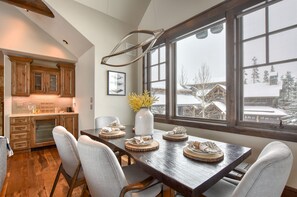 The dining area to the left of the couches. 