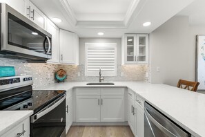 Spacious Kitchen with Quartz Countertops and Stainless Steel Appliances