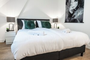 A comfortable and inviting bedroom with soft lighting, decorative pillows, and a serene atmosphere.