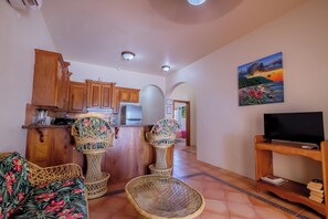 The living room with cable TV and breakfast bar. 2A