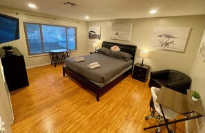 Main bedroom w/ California King, TV, office table and other sitting area 