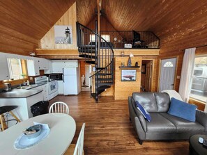 View from the front door, kitchen on left, loft master bedroom upstairs. 