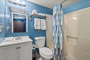 The ensuite bathroom has a tub and shower.