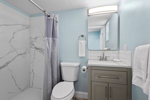 The ensuite bathroom has a shower.