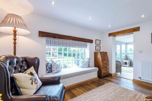 The spacious living room benefits from a 40-inch SMART TV with Netflix on the wall, plenty of space to sit down with family and friends in the evening, and a gorgeous log burner to keep warm in the evenings.