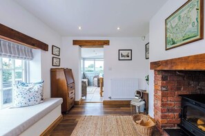 The spacious living room benefits from a 40-inch SMART TV with Netflix on the wall, plenty of space to sit down with family and friends in the evening, and a gorgeous log burner to keep warm in the evenings.
