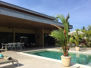 Poo and partially covered terrace with seating and lounging