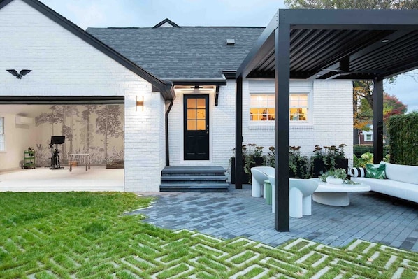 Back entry, pergola and view of studio.