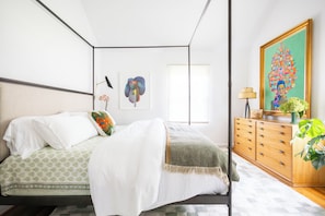 Primary suite with king size bed and adjoining bathroom.