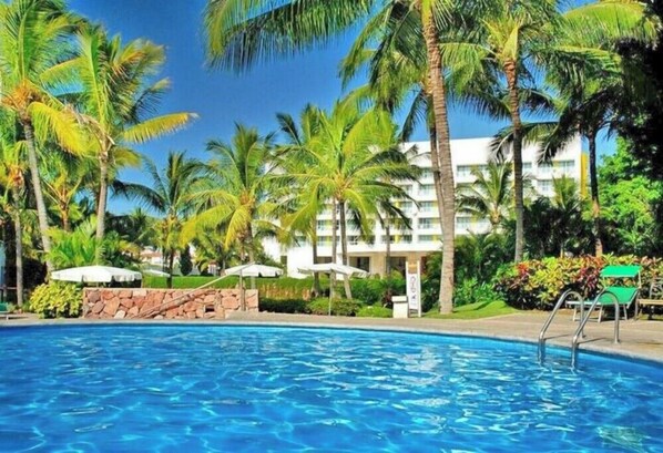 Lushy green gardens and a beachfront swimming pool are part of our property