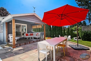 Covered lounge seating and outdoor dining by the pool
