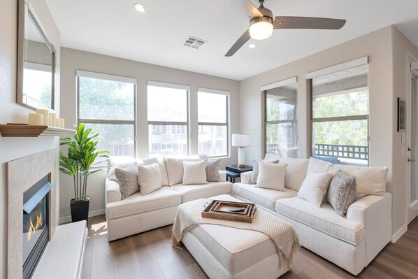 Living room with sofa, love seat, gas heater & 46" TV with Cable