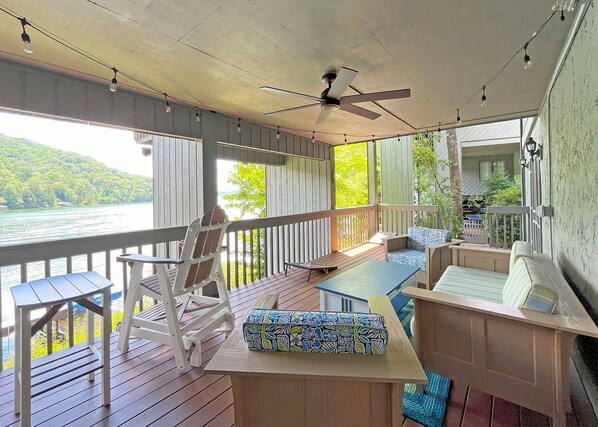 Covered Deck - Spacious covered deck. 2 rocking counter height chairs, sofa and 2 chairs. A ceiling fan operated by remote and Cafe lights on a timer add to the ambiance.