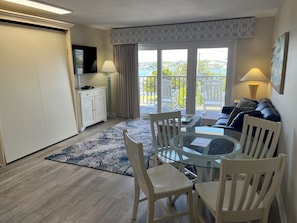 Compact, functional common room with a queen murphy bed