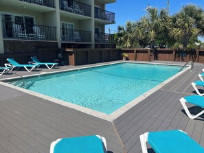 Sparkling resort pool close to the ocean and local tourist attractions.