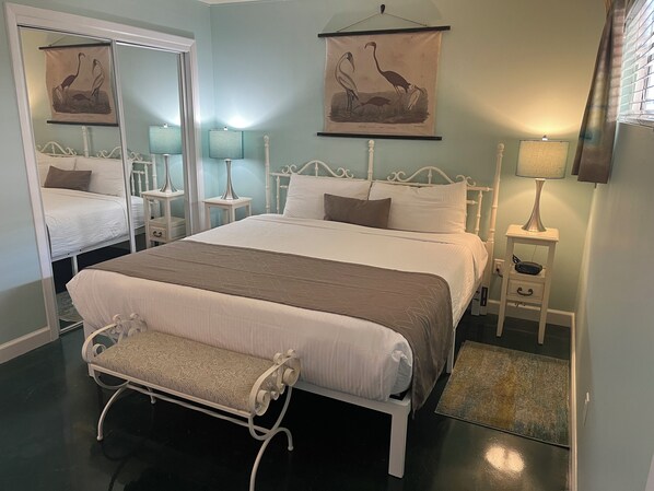 Serene, elegantly furnished room featuring a plush king-size bed