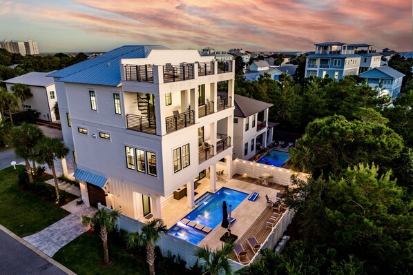 Seas the Day—your perfect group getaway that SLEEPS 24! Just steps from PRIVATE beach access, this stunning retreat includes a FREE golf cart. Unwind in the backyard oasis with a heated pool, hot tub, outdoor kitchen, and lounge seating. Plus a game room!