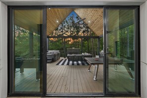 Through the sliding glass door, find your private, scenic oasis. Relax in the hot tub with your fave show on the TV & the scent of bbq from the grill filling the air. Enjoy breathtaking views, a good book, or a game of ping pong or foosball!