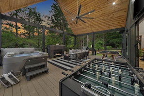 You will love this scenic and secluded patio - hot tub with view of breathtaking nature and 65" TV, grill with gas provided, modern gas fireplace, patio seating set, Outdoor 65" TV, ping pong and Foosball.