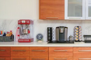 Kitchen is stocked with popcorn machine, snow cone machine and coffee machine.