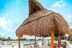 It’s a breezy and lovely place for a sunset cocktail under the rooftop Palapa
