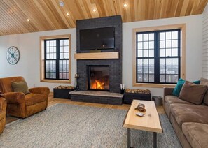 Cozy fire place living room features high ceilings and a full view of St. John's!