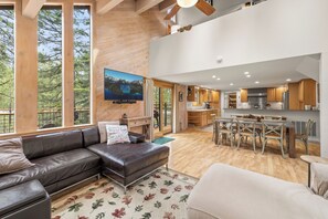 Open great room space w/
L-shaped couches, gas fireplace,  TV, and dining for 8