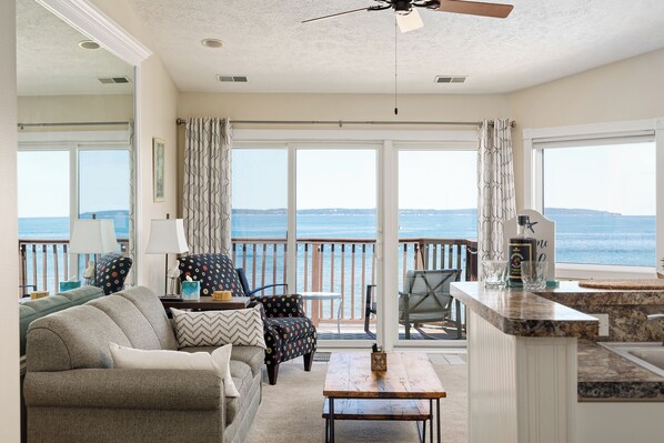 Spacious living room with breathtaking views of the bay! Don't miss the spectacular sunsets.