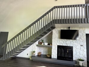 Large living room tv and wood fireplace