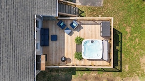 A large back deck has comfortable seating and a hot tub for six.