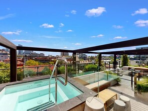 Chill out in the shared outdoor lounge area that has a hot tub!