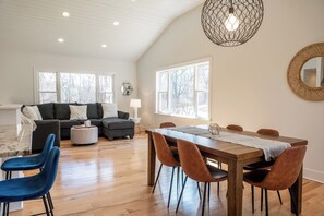 There's seating at the breakfast bar and dining table in the open concept living room.