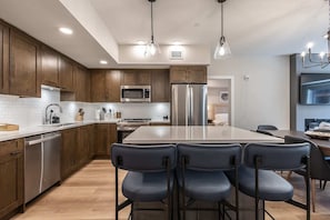 Kitchen features and island with a breakfast bar with seating for 3.