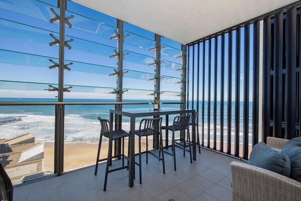 Raise a glass to perfect ocean sunsets on this undercover balcony. 

