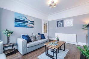 The spacious living space benefits from a sofa bed, a 40-inch smart TV and plenty of space to sit down and relax.