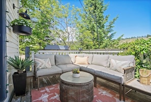 Walkout from the social room onto the private deck space with cozy seating & stunning mountain views.