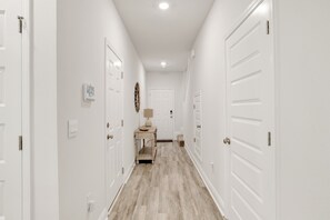 Foyer hallway with access to garage and 1/2 bath room