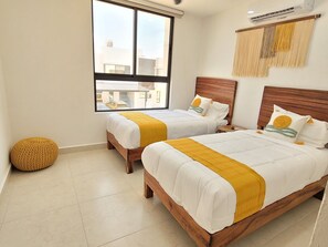 Bedroom 2 with 2 twin beds., A/C and ceiling fan.