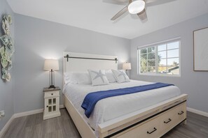 King bed in master bedroom with attached bathroom