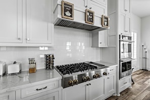 Modern kitchen with stovetop, dual ovens, and sleek design for effortless meals!