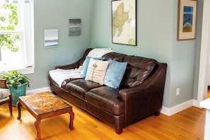 Large couch with comfy pillows and fuzzy throw blanket