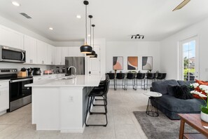 The living room, dining area and kitchen perfectly integrate into one ambience, ideal for socializing during the holidays.