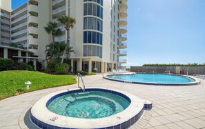 Resort-style hot tub and pool area with a relaxing outdoor atmosphere, perfect for unwinding.
