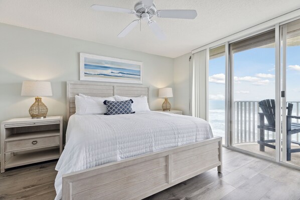 Master bedroom with a luxurious king-size bed, and private balcony access.