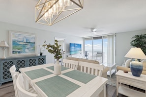 Elegant dining room leading to the living area and balcony.